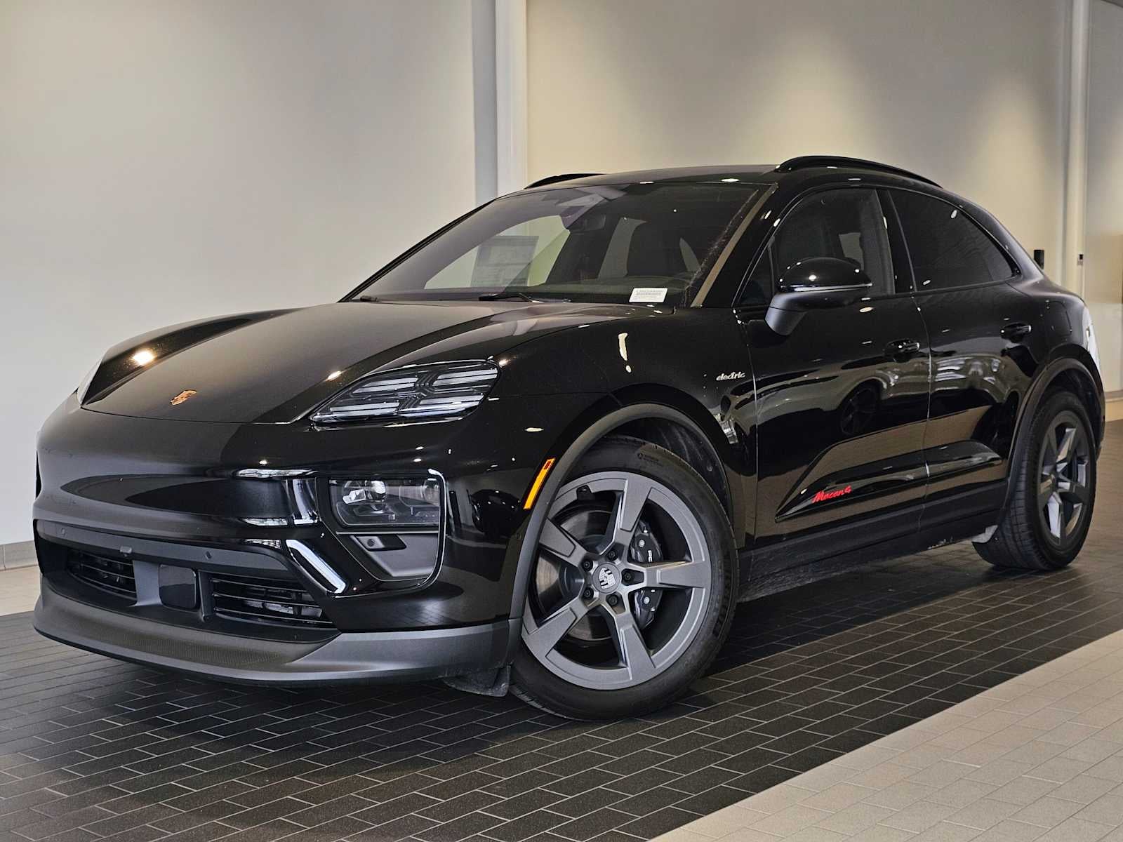 2024 Porsche Macan Macan 4 Electric in Jet Black Metallic — front three-quarter view